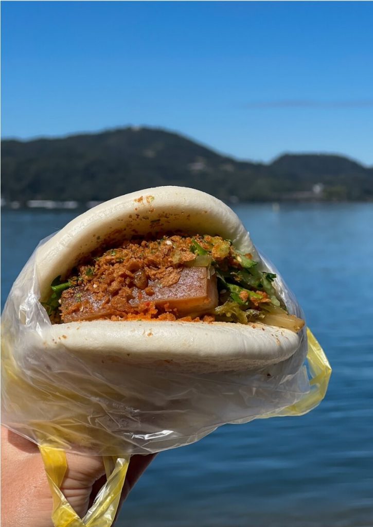 a delicious Taiwanese style hamburger packed with juicy pork belly and cilantro stuffed in a soft steamed bun
